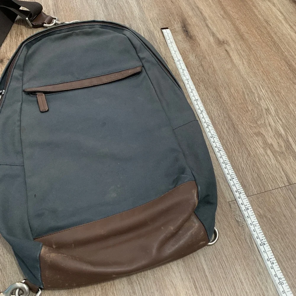 Coach 2013 canvas sling backpack in navy blue w/ brown leather panels - 13x18in‎